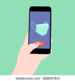 Smartphone with medical face mask and buy button on the screen.  Contactless online purchase of goods using your phone.  Diseases prevention. Home deliVery.