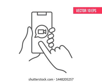 Smartphone or mobile phone in a human's hand with video chat icon. Mobile Phone Line Icon. Hand holding smartphone.