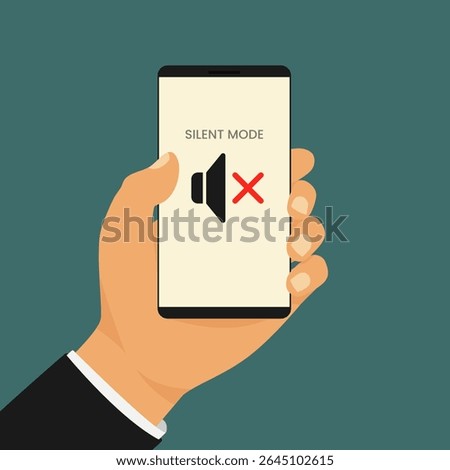 Smartphone in silent mode held by man. Hand holds a smartphone displaying a muted speaker icon with the words Silent Mode