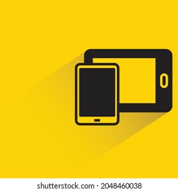 smartphone and tablet with shadown on yellow background