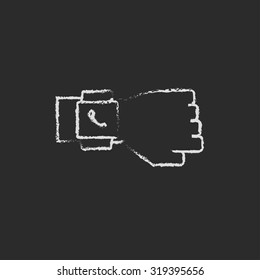Smartwatch hand drawn in chalk on a blackboard vector white icon isolated on a black background.