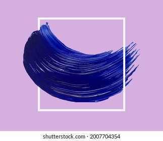 A smear of blue acrylic paint with a frame. A trace of fresh paint from an artistic brush with a glossy texture. A frame, a place for your text, a decorative design element.