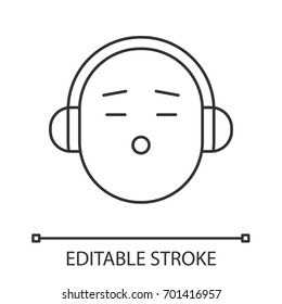 Smile with headphones linear icon. Thin line illustration. Listening to music smiley. Contour symbol. Vector isolated outline drawing. Editable stroke