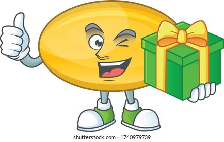 Smiley oil capsule cartoon character holding a gift box