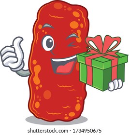 Lächelnd Acinetobacter Bakterien Karikaturencharakter mit einer grünen Geschenkbox