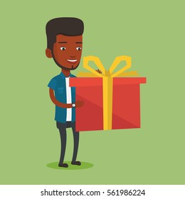 Smiling african-american man holding a box with gifts in hands. Happy man holding gift box. Young man standing with gift box. Guy buying a present. Vector flat design illustration. Square layout.