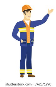 Smiling asian builder showing a direction. Full length of young builder pointing at something and showing a direction by his hand. Vector flat design illustration isolated on white background.