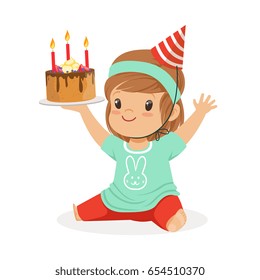 Smiling baby girl wearing a red party hat sitting and holding birthday cake with three candles. Childrens birthday party colorful cartoon character vector Illustration
