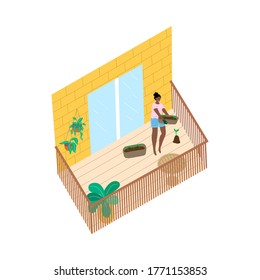 Smiling black woman standing on balcony and moving pots with growing sprigs