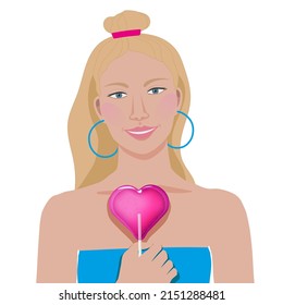 A smiling blonde girl with a heart-shaped lollipop (candy) in her hand, in a blue summer top and with earrings on her ears with a bun hairstyle