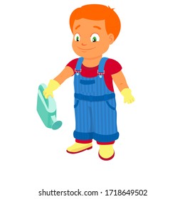 Smiling boy dressed in a shirt, denim overall, watertight boots and gloves holds a watering can in the right hand. Concept of a child helping out with the work around the house or in the garden.