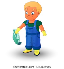 Smiling boy dressed in a shirt, denim overall, watertight boots and gloves holds a watering can in the right hand. Concept of a child helping out with the work around the house or in the garden.