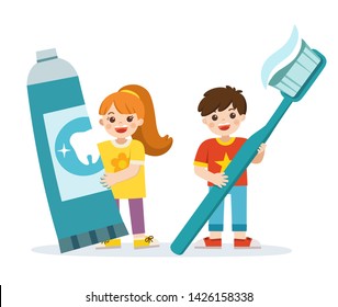 Smiling boy and girl standing, holding toothbrush and toothpaste. showing healthy teeth hygiene and care.