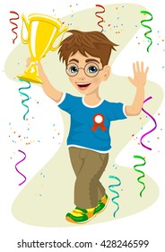 smiling boy with glasses celebrating his victory with trophy