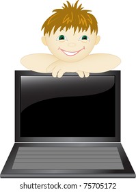 smiling boy looks from behind of the open laptop
