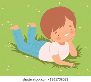 Smiling Boy Lying Down on Green Lawn on his Stomach, Cute Kid Having Fun Outdoors Cartoon Vector Illustration