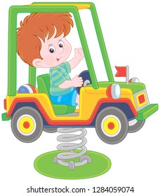 Smiling boy on a toy car swing on a playground, vector illustration in a cartoon style