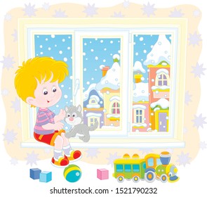 Smiling boy playing with his small grey kitten on the windowsill of a nursery on a snowy winter day, vector illustration in a cartoon style