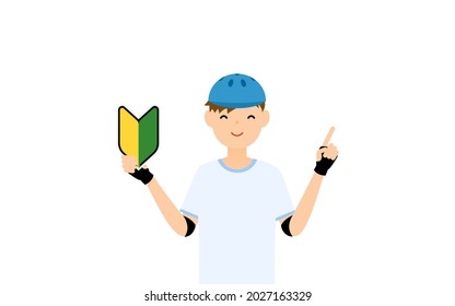 A smiling boy skater holding a beginner's mark in his hand