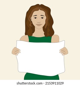 A smiling brunette girl in a green dress with a white empty poster in her hands, suitable as a template for any inscription or message