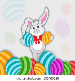 Smiling bunny holding glossy eggs For Happy Easter.