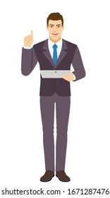 Smiling Businessman holding digital tablet PC and pointing up. Full length portrait of Businessman in a flat style. Vector illustration.