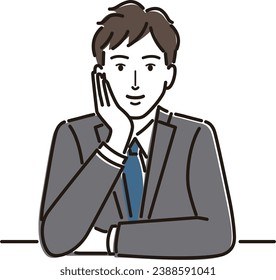 Smiling businessman resting on his chin