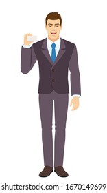 Smiling Businessman shows the business card. Full length portrait of Businessman in a flat style. Vector illustration.