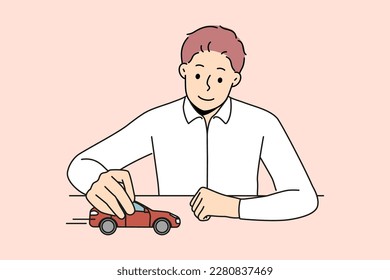 Smiling businessman sit at desk play with red car. Confident man boss or CEO playing with automobile think of next business move. Vector illustration. 