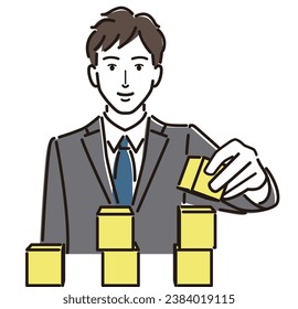 Smiling businessman stacking building blocks