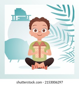 Smiling child boy sits in a lotus position and holds a box with a bow in his hands. Birthday, new year or holidays theme. Vector illustration in cartoon style.