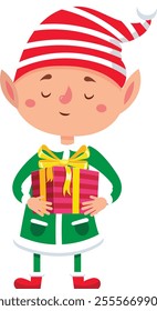 Smiling christmas elf wearing green clothes and red and white striped hat holding wrapped gift box with golden ribbon, isolated on white background