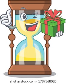 Caricatura del croniómetro sonriente con una caja de regalo verde