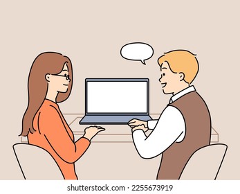 Smiling colleagues sit at desk working together on computer. Happy employees or coworkers cooperate at laptop in office. Teamwork and collaboration. Vector illustration. 