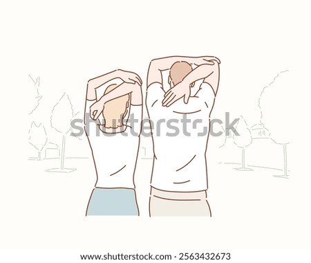 smiling couple doing streching in the park.