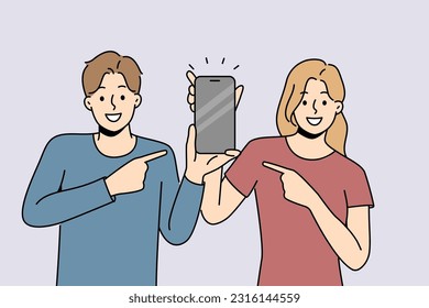 Smiling couple point at cellphone with empty screen. Happy man and woman point with finger on smartphone. Recommendation and technology. Vector illustration. 