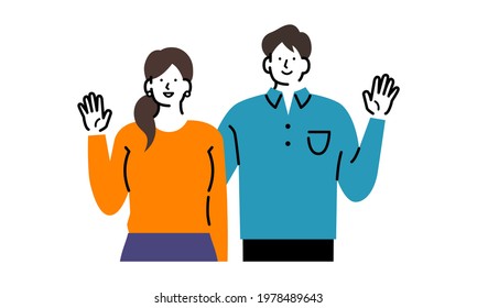 A smiling couple raising their hands