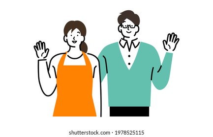 A smiling couple raising their hands