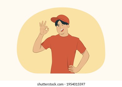 Smiling delivery young man showing ok gesture concept