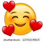 Smiling emoticon with three hearts