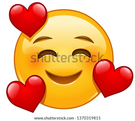 Smiling emoticon with three hearts