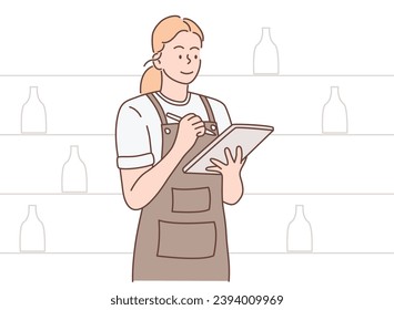 smiling female barista holding pen and tab