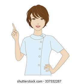 A smiling female dental assistant in light blue uniform pointing up with her index finger