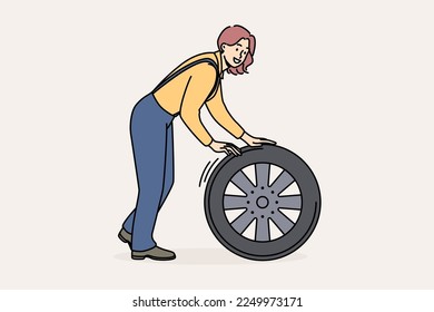 Smiling female mechanic with car tire working at auto repair service. Happy woman engineer busy with wheel repairing automobile. Vector illustration. 