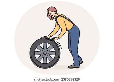 Smiling female mechanic with car tire working at auto repair service. Happy woman engineer busy with wheel repairing automobile. Vector illustration.