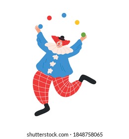 Smiling funny clown in costume juggling with colorful balls during performance in circus