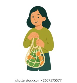 Smiling girl holding a reusable mesh bag full of vegetables and greens. Zero waste lifestyle.