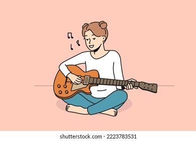 Smiling girl sit on floor playing guitar. Happy female enjoy musical lesson with instrument. Hobby and entertainment. Vector illustration. 