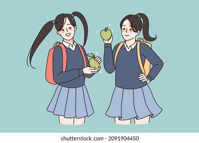 Smiling girls pupils in school uniform and backpacks having lunch eating apple. Happy female students enjoy break in college or university. Education and learning concept. Flat vector illustration. 