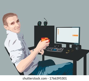 Smiling guy sitting at a desk with a computer